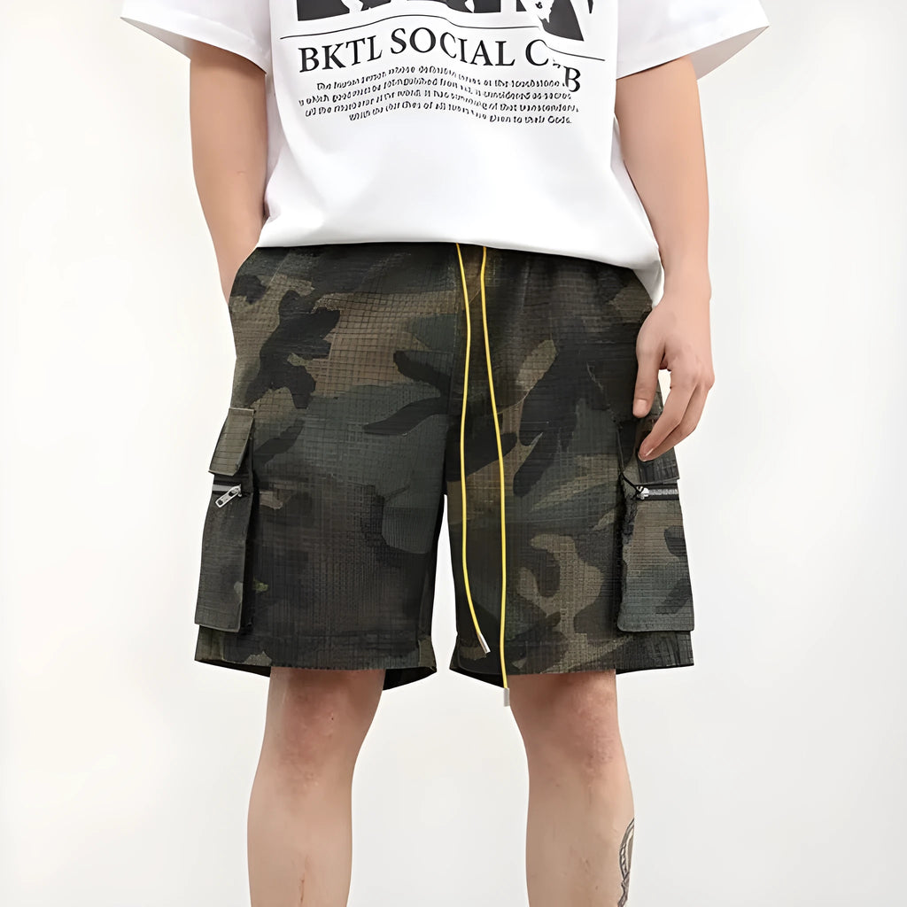 Multi-pocket camouflage workwear shorts for men with mid-waist cropped design and thin fabric, shown in a flat lay.