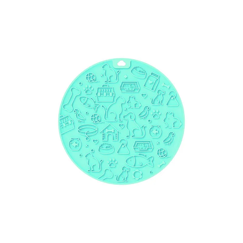 Round silicone pet licking mat with suction cup base in blue, on a kitchen tile floor.