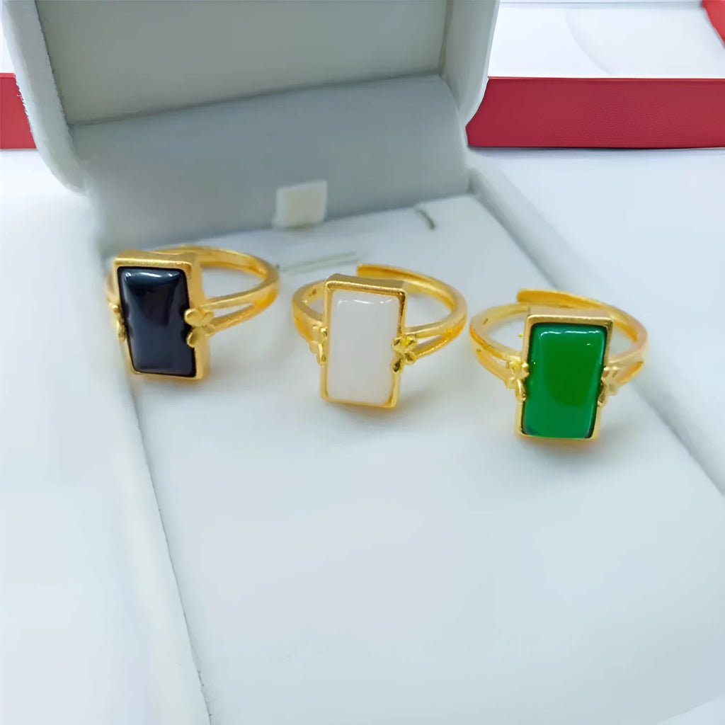 Adjustable brass gold-plated ring with electroplated gemstone inlay showing black, green and white colour options