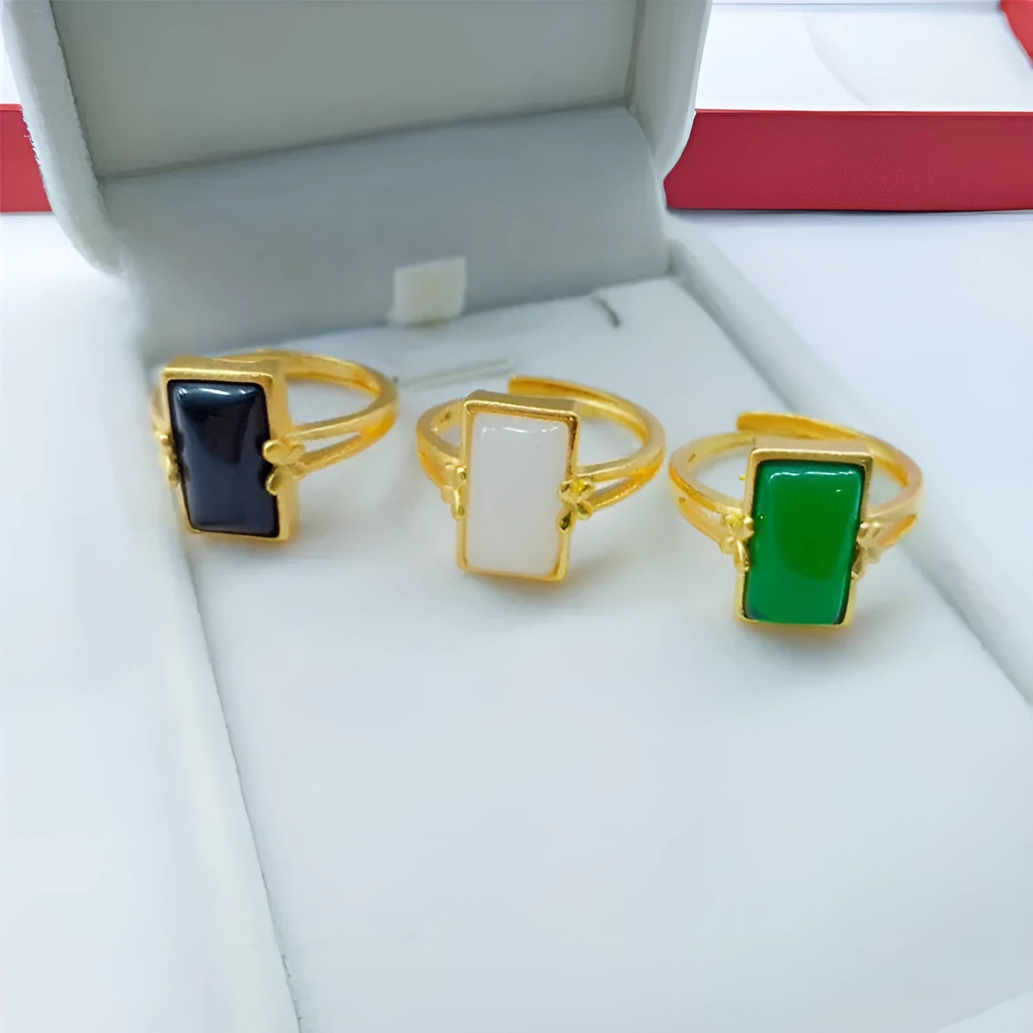 Adjustable brass gold-plated ring with electroplated gemstone inlay showing black, green and white colour options