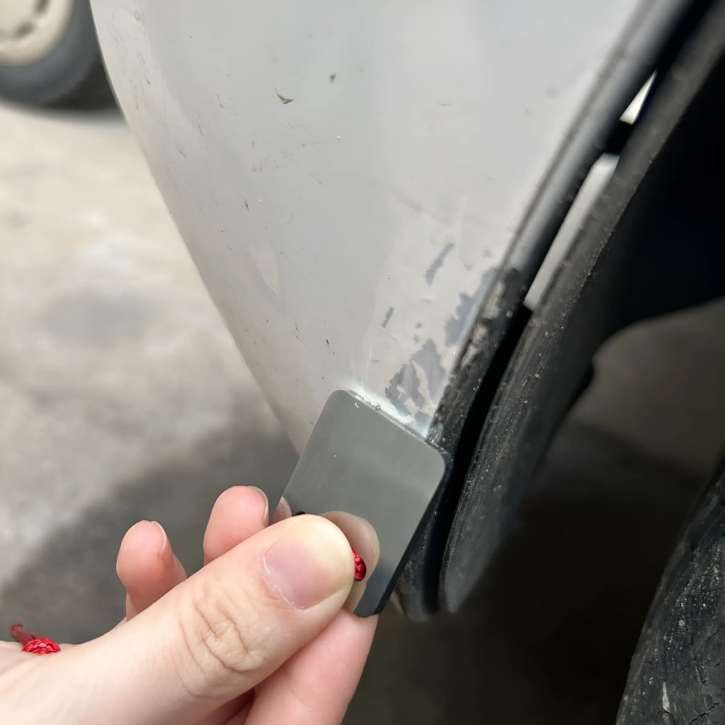 Silver metal car paint point repair scraper on surface