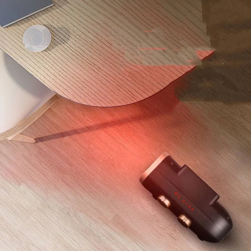 Small white electric heater fan with mechanical controls on a wooden floor
