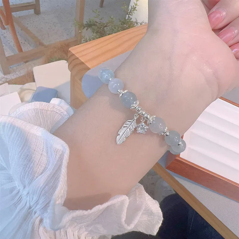 Small white girl crystal bracelet in Feather XINGX Blue Moonlight with eight Awn star and text design