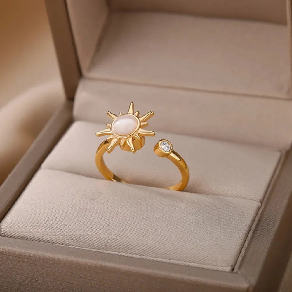 Simple gold adjustable spinner ring with rotating geometric component on a finger.