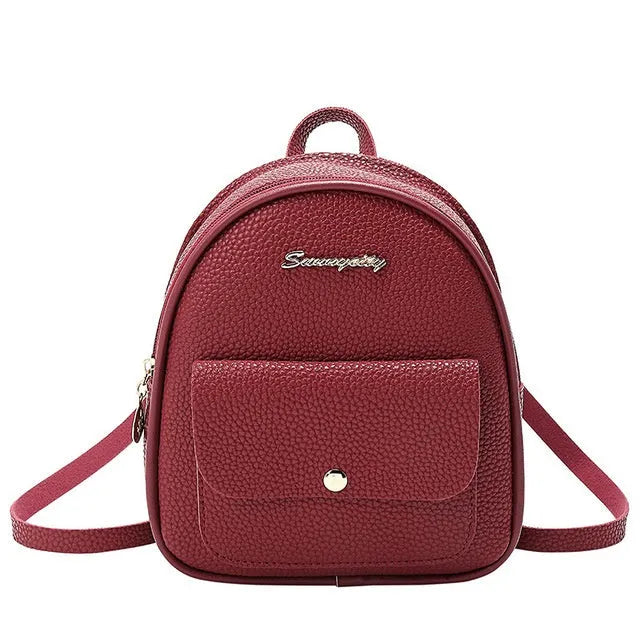 Women's small PU shoulder backpack in solid colour with convertible strap design and zipper closure