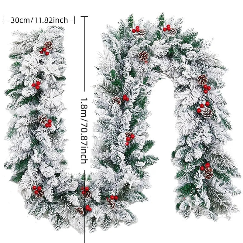 Christmas rattan-style PVC garland with white flocked snow detailing in coiled display