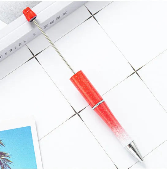 Colourful spinning beaded ballpoint pen showing bead mechanism and writing tip