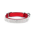 Adjustable black velvet suede cat collar with sparkling rhinestone decoration on a grey background.