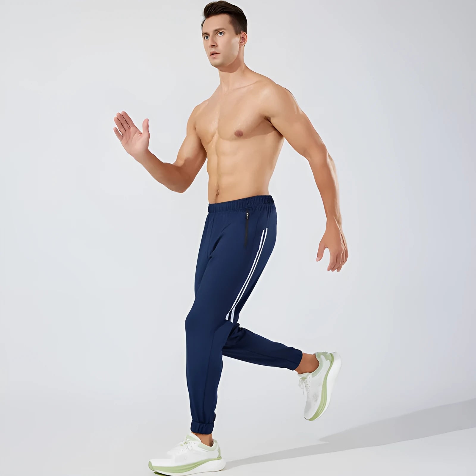 Man wearing black full-length polyester running trousers with a mid waist.