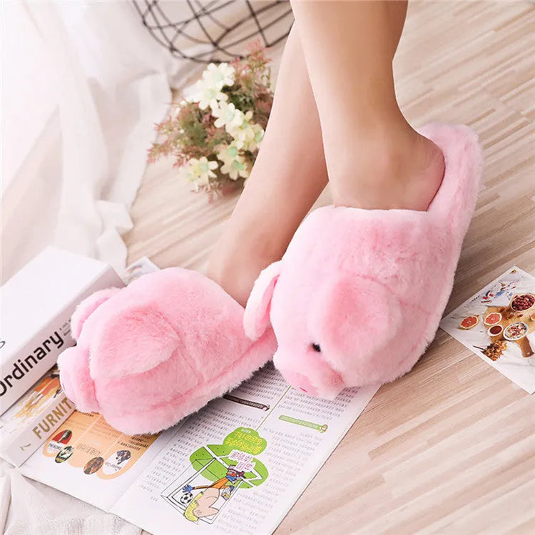 Pink pig floor slippers with soft plush exterior and cushioned interior for indoor wear