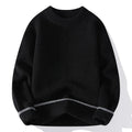 Man wearing a loose grey round neck pullover sweater, casual autumn outfit