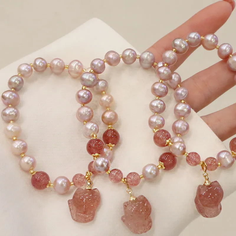 Women's natural freshwater pearl bracelet with light pink pearl, strawberry quartz, and fox charm on string