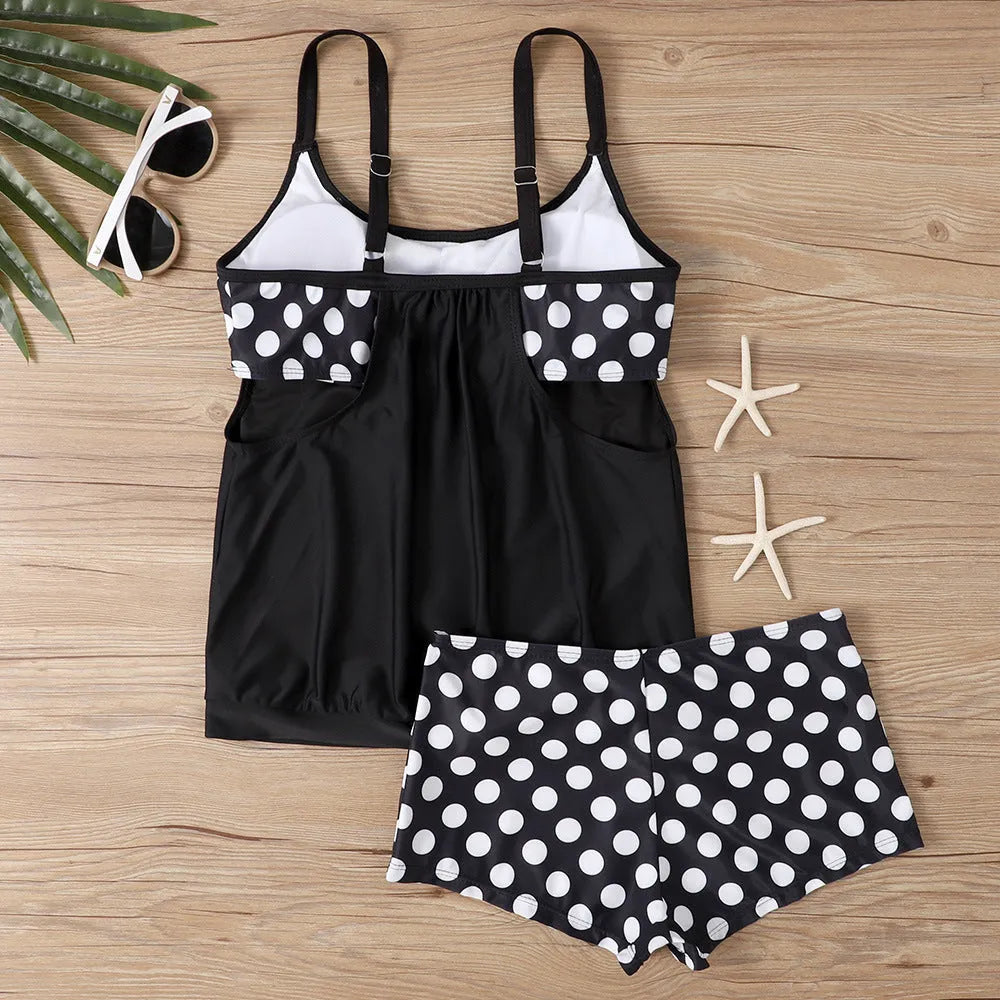 Women's black polka dot high-waisted boxer swimsuit laid flat, showing brief style and print detail.