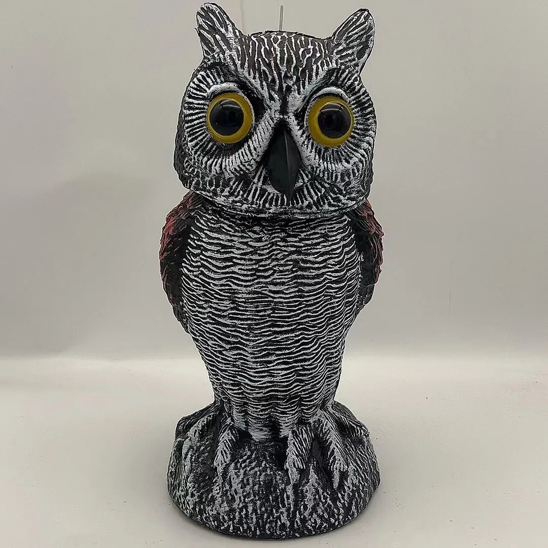 Artificial owl garden ornament with shaking head for bird deterrent on patio