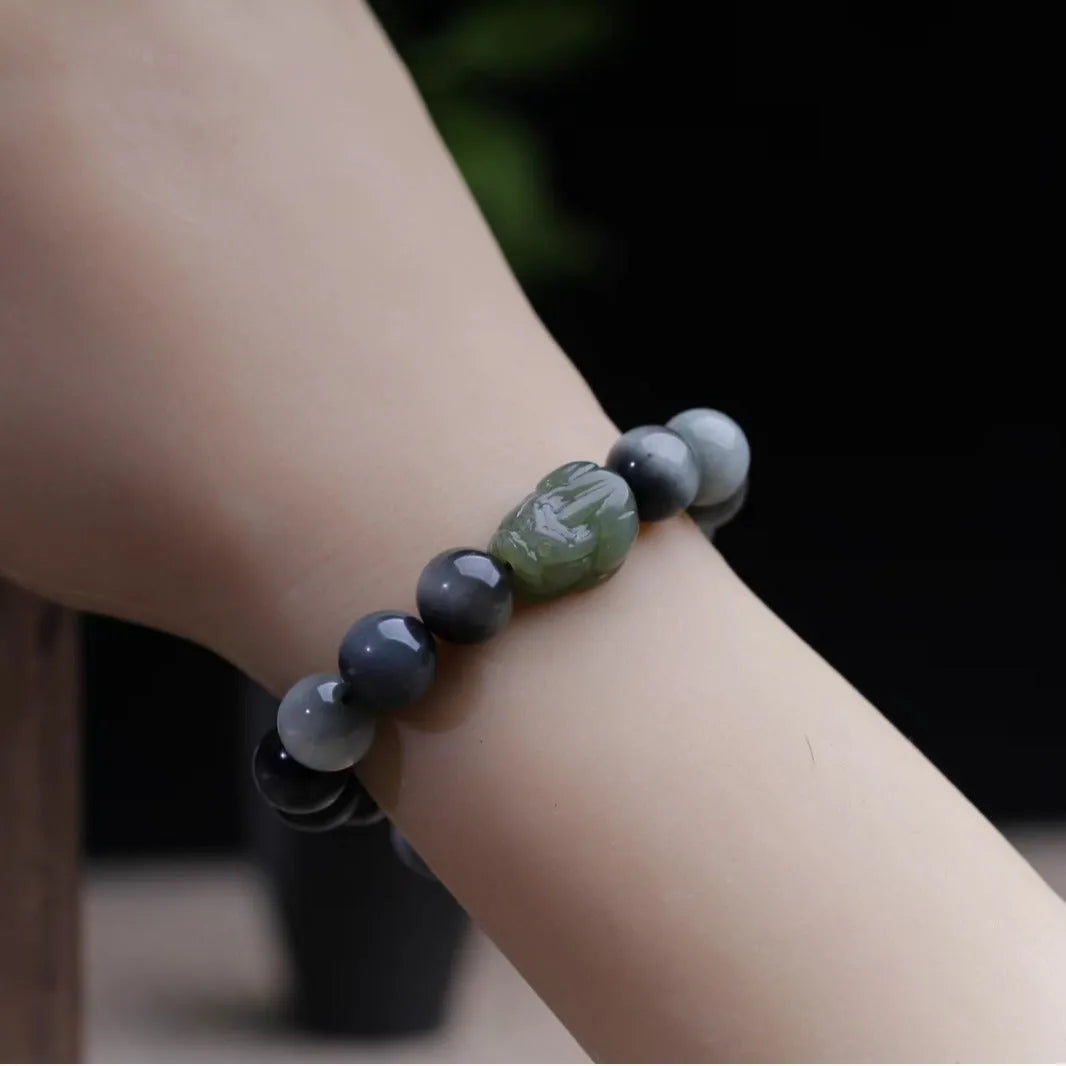10mm black eagle eye stone and natural Hetian jade clear water Pixiu bracelet on a neutral background