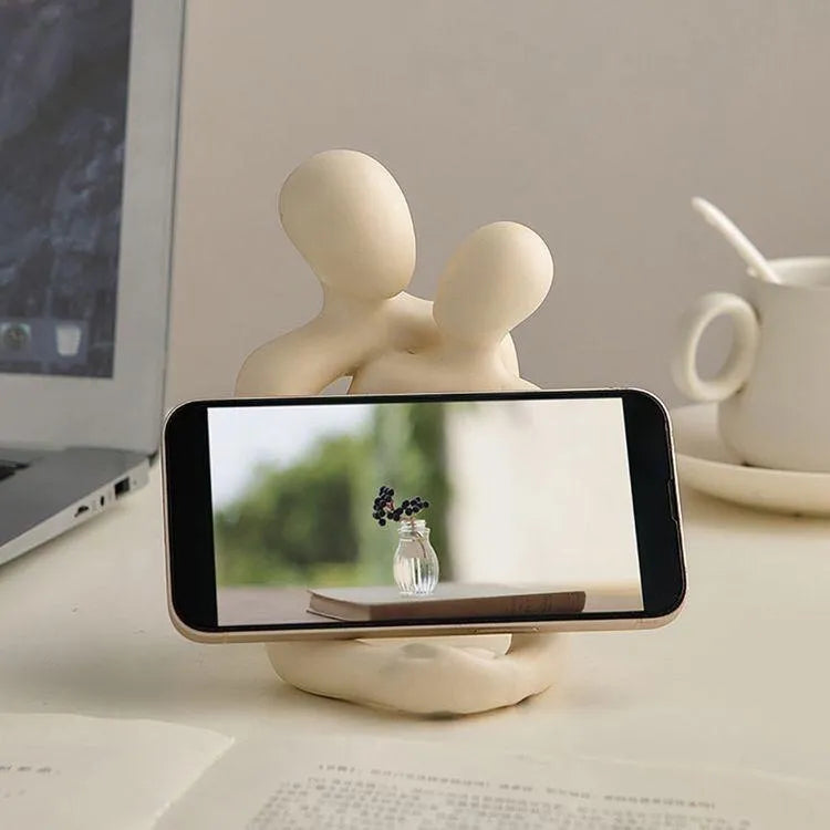 Modern couple resin statue in gold colour placed on a white bookshelf as home decor accent