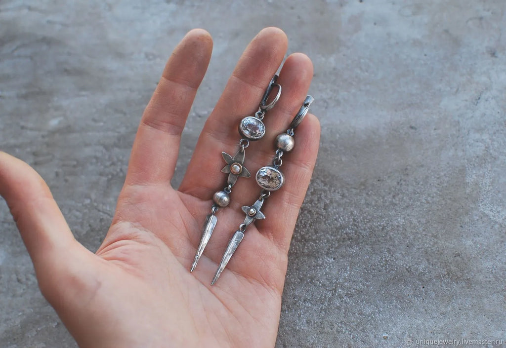 Geometric XINGX pendant earrings with antique silver plating and rhinestone details