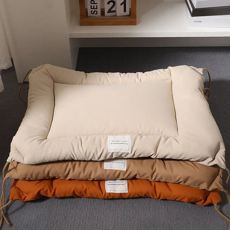 Beige cage cushion tied in a wire dog crate with soft padding for small pets