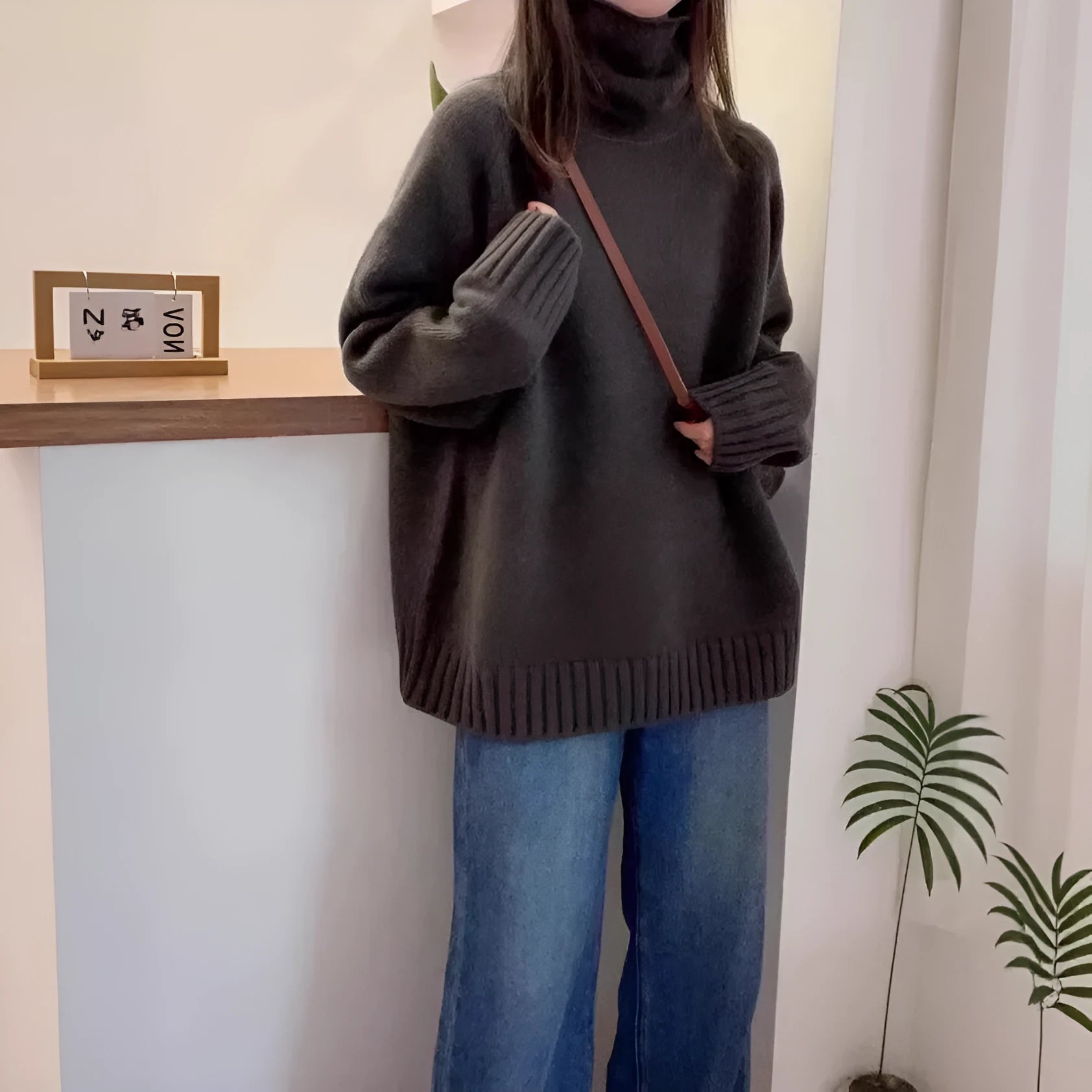 Women's thick loose turtleneck sweater with curling collar and 3D pattern in camel colour.