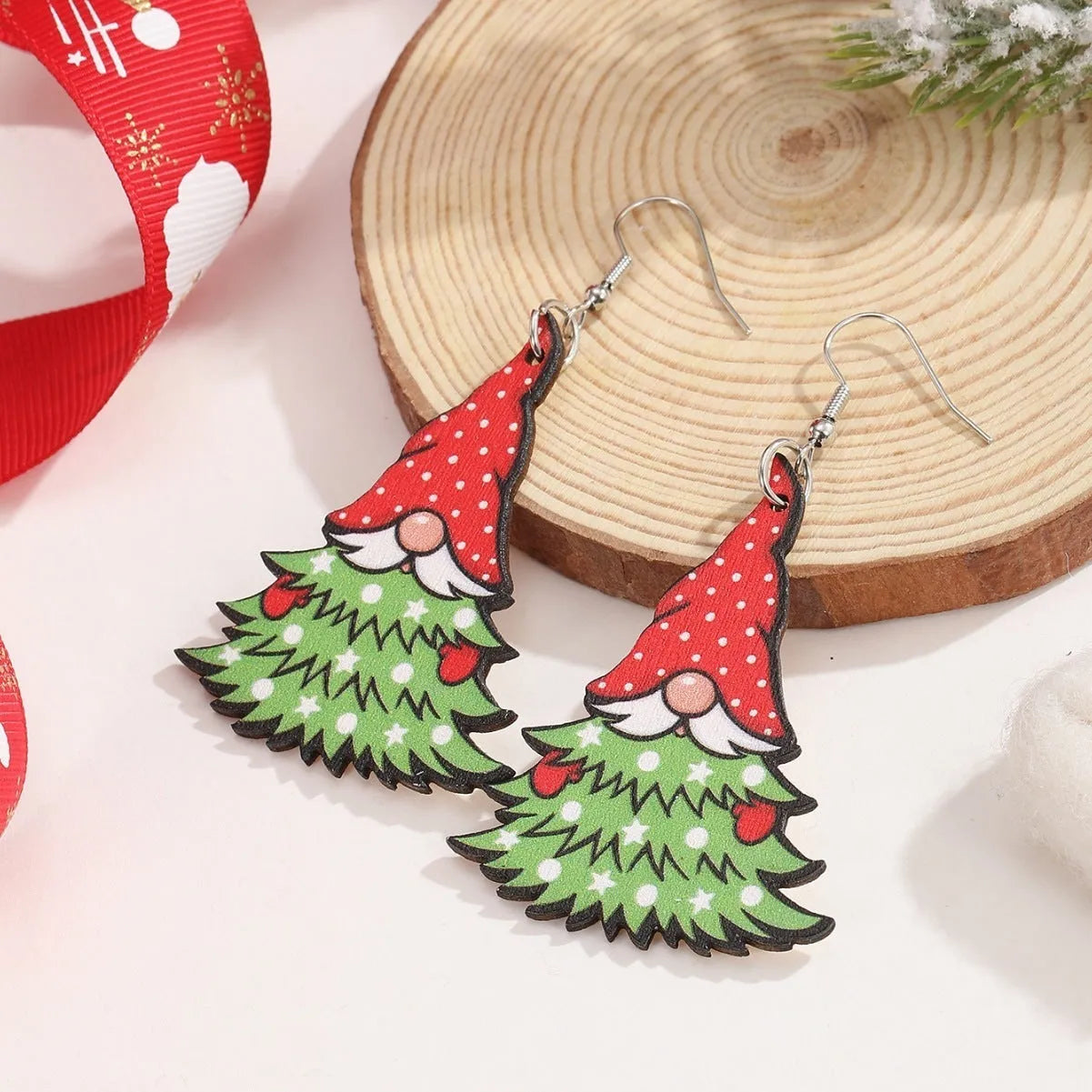 Women's wooden Christmas earrings showing Christmas tree and water drop snowman designs with Santa Claus elements