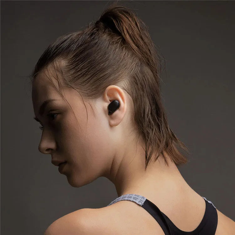 Redmi AirDots True Wireless black earbuds and charging case on a white background.