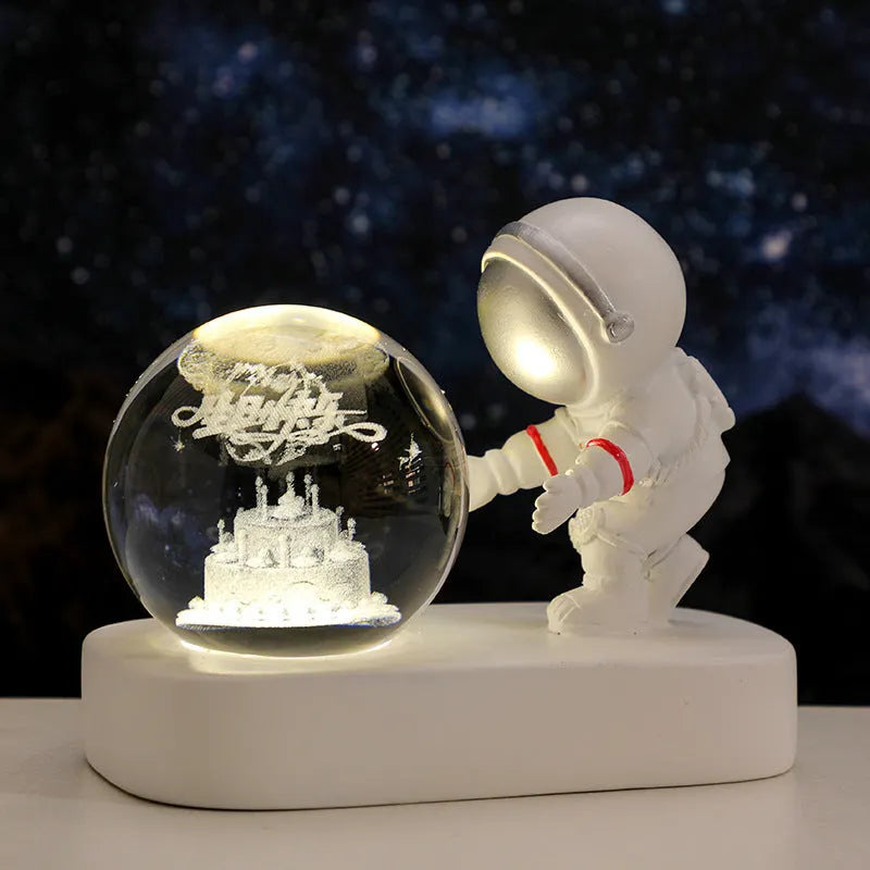 Clear resin crystal ball night light with glowing astronaut pattern on USB base