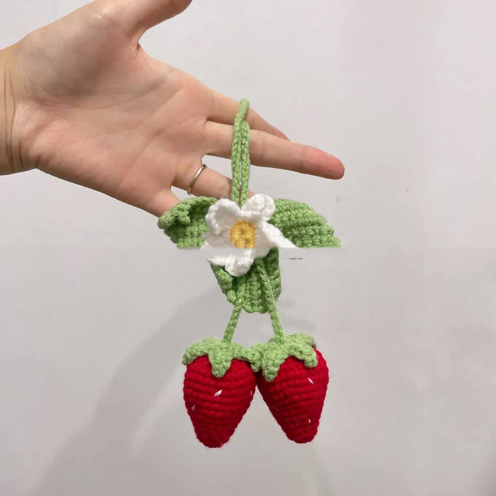 Handmade strawberry-shaped car weaving pendant made from cotton and hemp fibres.