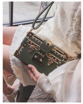 Hard-structured women's black PU leather shoulder bag with flap and rivet decoration