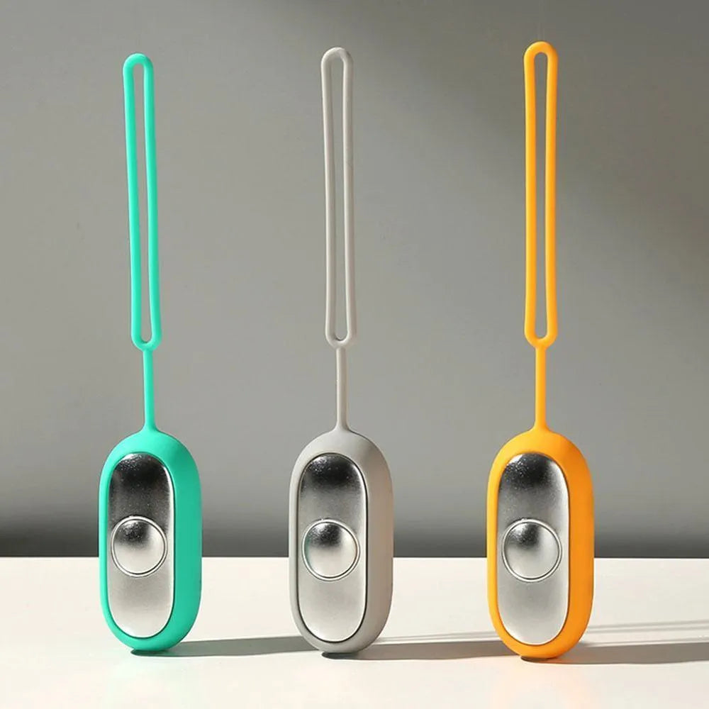 Hand-held micro-current sleep aid device with round button and stainless steel electrodes in grey colour