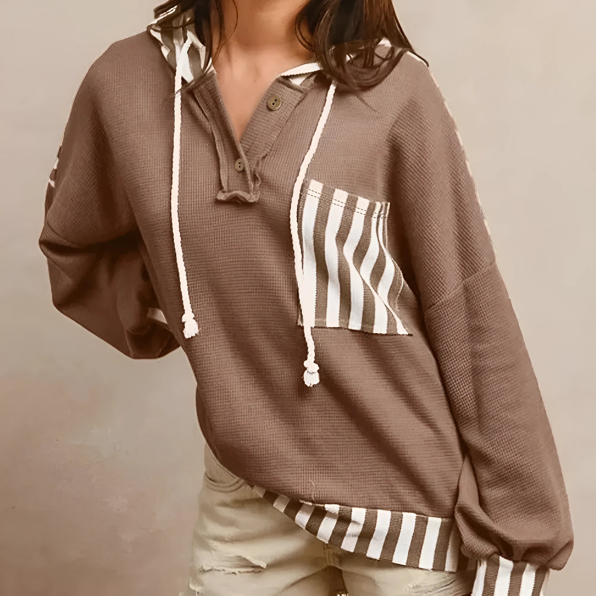 Straw yellow waffle texture hoodie with striped patchwork panels and button neck closure
