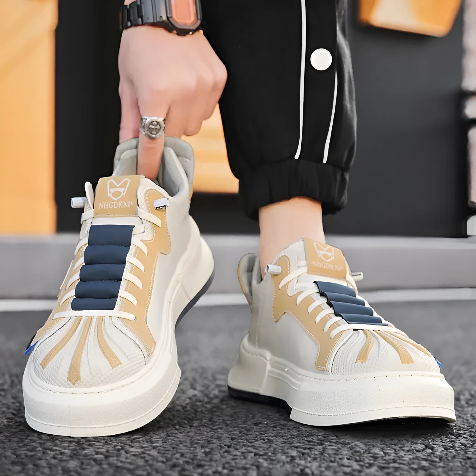 Men's beige and black low-top sneakers with elastic band and mesh lining