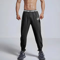Loose cropped sports trousers in grey with printed waistband, moisture-wicking fabric for women