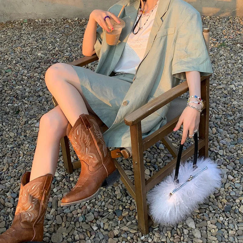 Brown women's embroidered mid-calf Martin boots on a white background, showing round toe and low square heel.