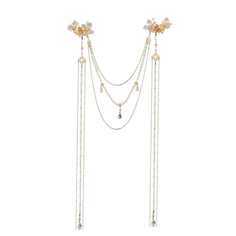 Gold acrylic hairpin with a pearl and diamond flower decoration and a long tassel.