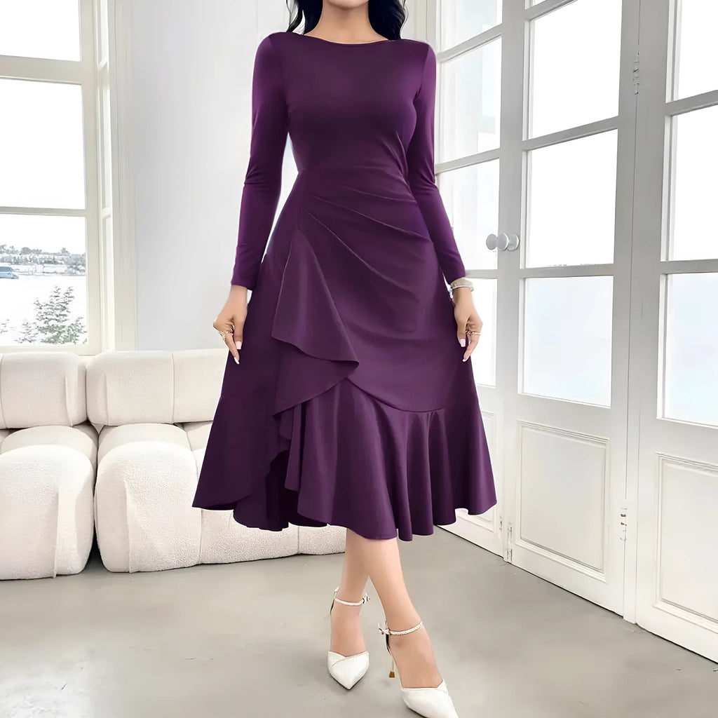 Purple women's dress with ruffled detailing, long sleeves and round neckline on mannequin