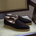 British handmade brown leather loafers for men on a white background.