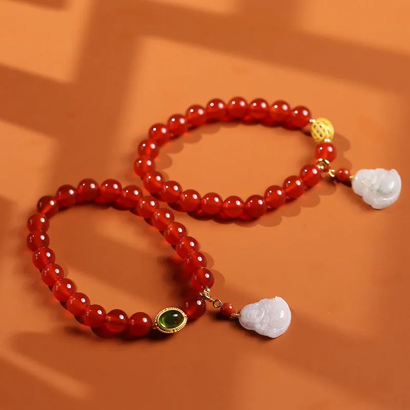 Chinese style women's bracelet with red agate, amber beads and gold Maitreya Buddha pendant on wrist