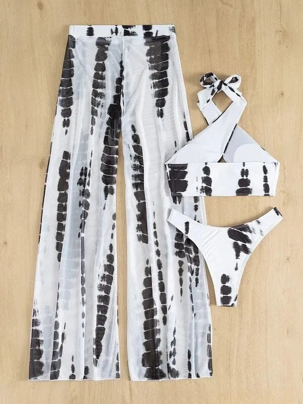 Women's black and blue printed three-piece swimsuit set with bikini top and mesh trousers.
