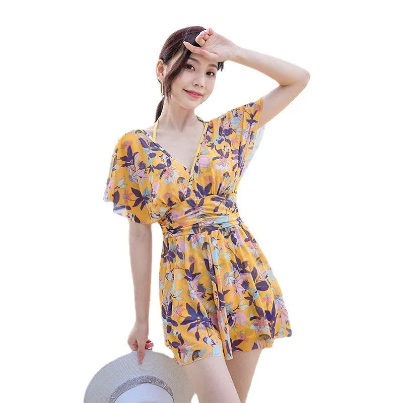 Women's yellow floral one-piece swimsuit with attached skirt, made from polyester, available in multiple sizes