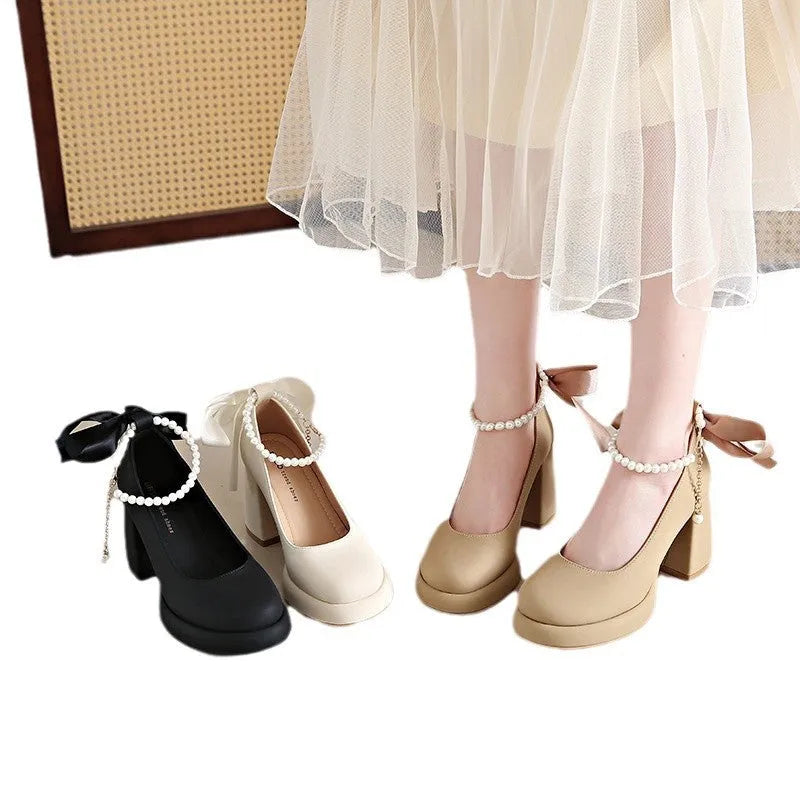 Beige women's Mary Jane shoes with chunky heel, ankle strap buckle, and pearl decoration on round toe