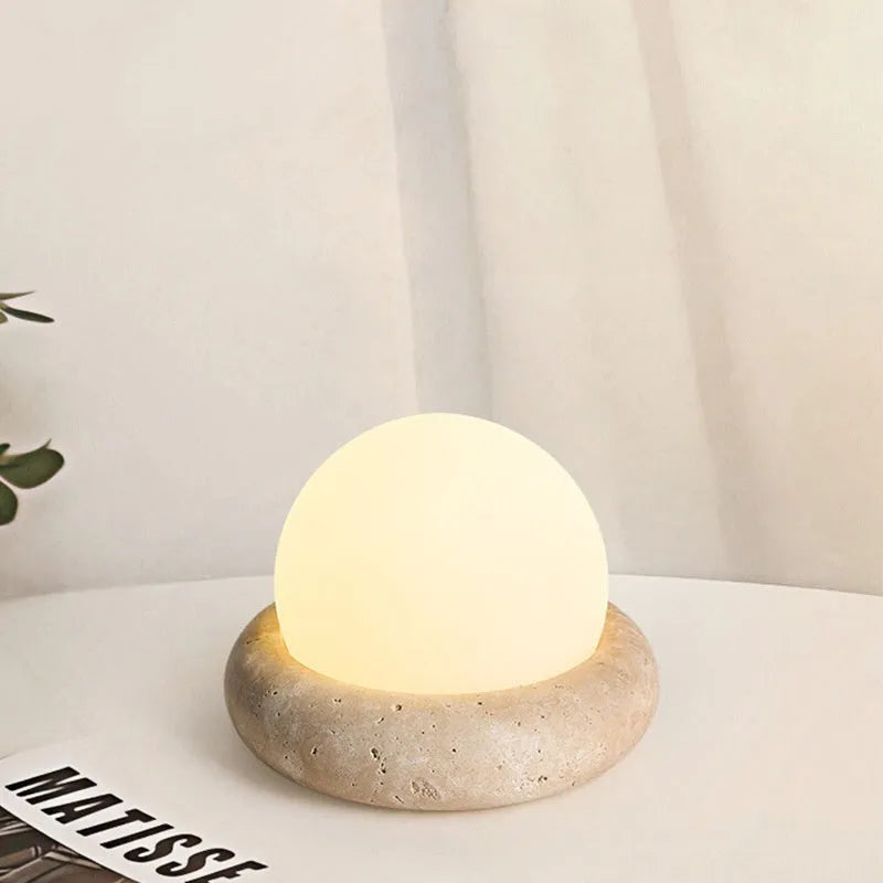 Cream modern bedside night lamp with remote control on wooden nightstand