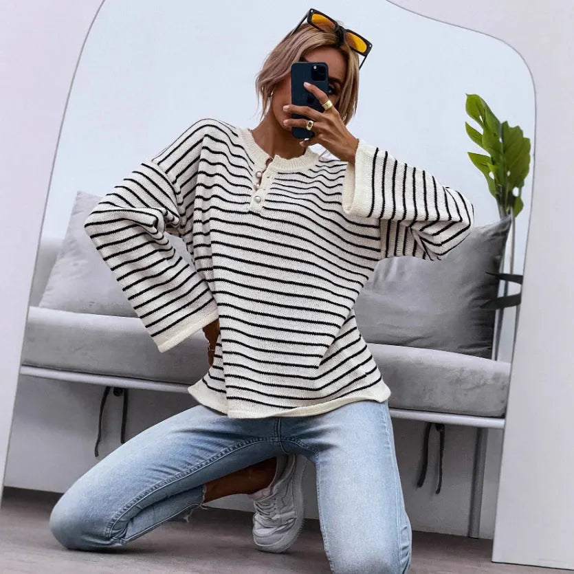 Women's black and white striped loose top with drop-shoulder sleeves and button details