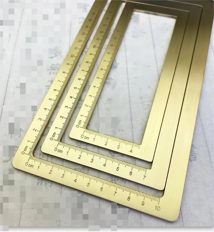 Solid brass square calligraphy paper weight with hand engraved surface on desk