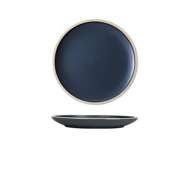 Blue matte ceramic plate with sesame point glaze on a table, 10 inch diameter.