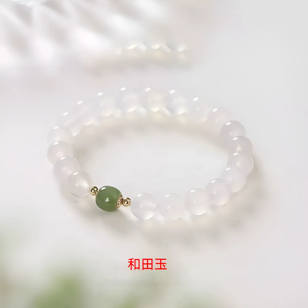 Handmade white agate crystal bracelet with cinnabar accents showing 6mm and 8mm bead sizes