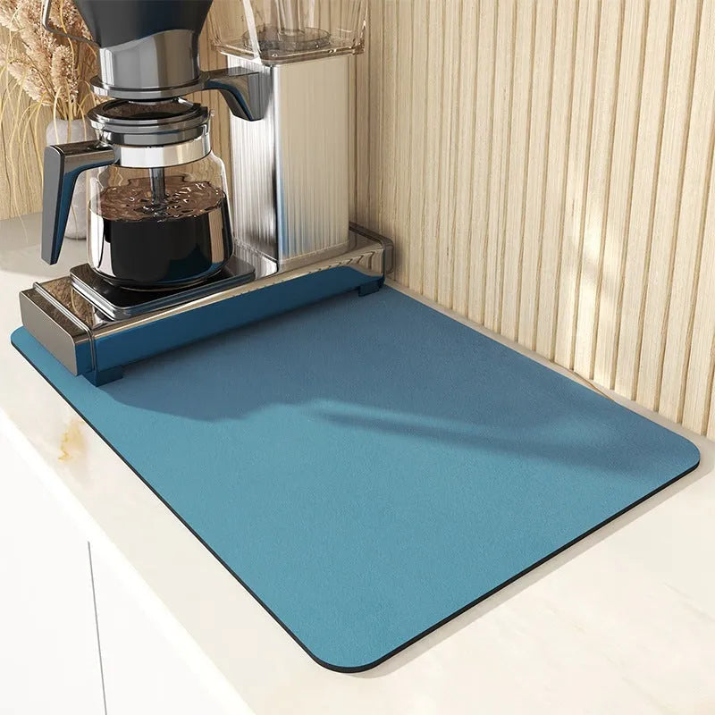 Super absorbent dish drying mat in black PU leather with non-slip rubber backing on a kitchen counter