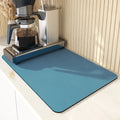 Super absorbent dish drying mat in black PU leather with non-slip rubber backing on a kitchen counter
