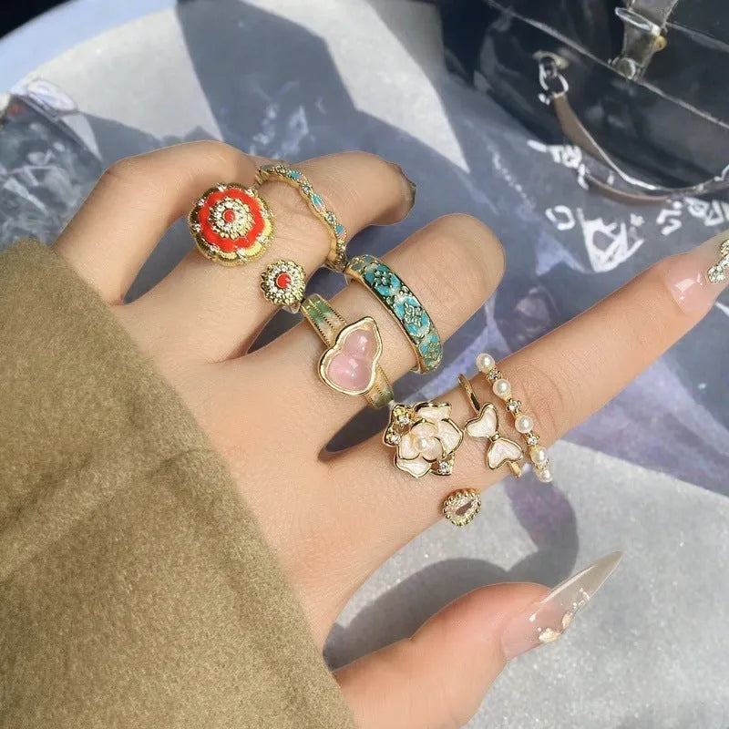 Adjustable copper ring with vintage oil dripping gourd, flower, and bow design and inlaid zircon stones.