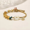 Hand-woven citrine crystal bracelet with zodiac design on neutral background