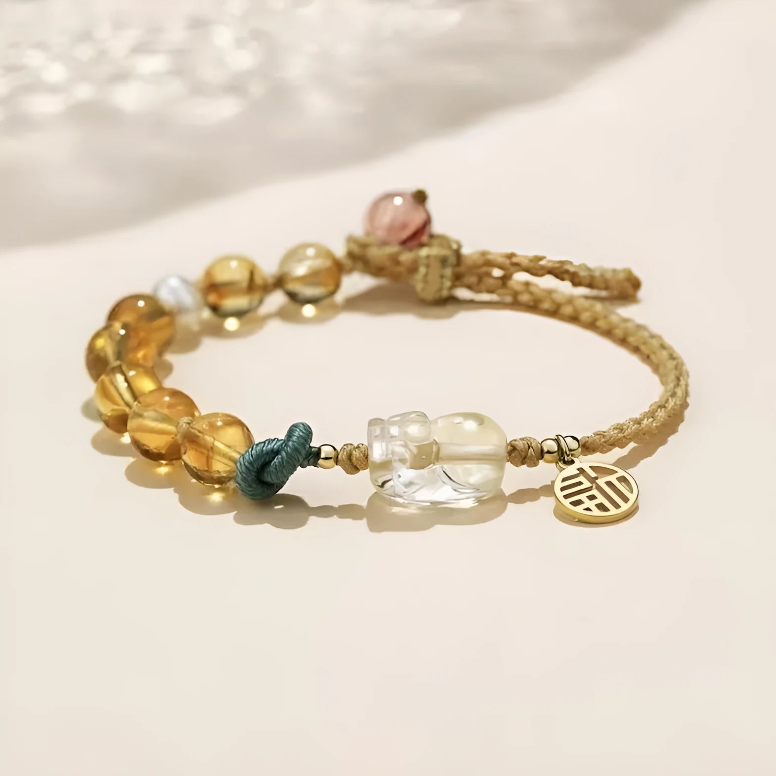 Hand-woven citrine crystal bracelet with zodiac design on neutral background